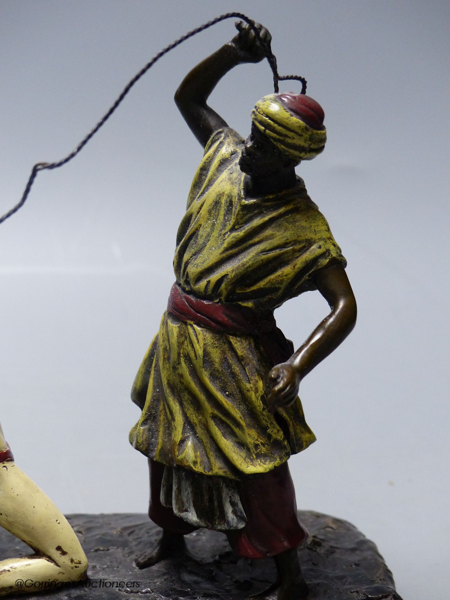 Attributed to Franz Bergmann, a cold painted bronze model of a slave trader, whipping a nude slave, stamped with shield and 'Nan Creb'